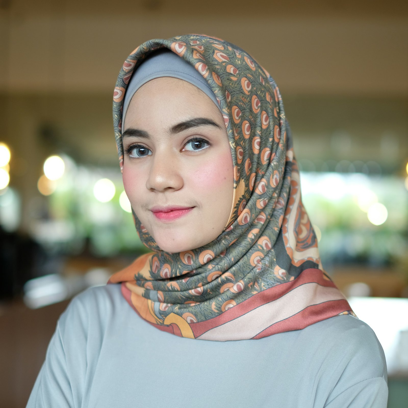 A woman wearing a gray hijab